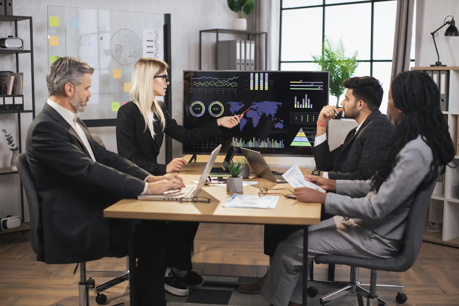 Business executives reviewing AI strategy, analytics dashboards, and enterprise performance insights
